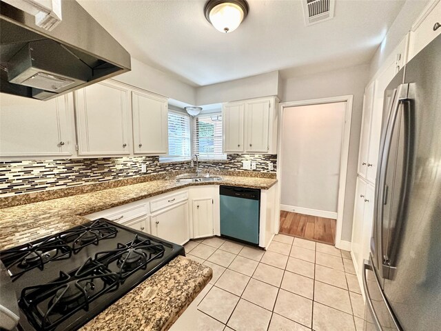 kitchen with range hood, stainless steel appliances, white cabinetry, and sink