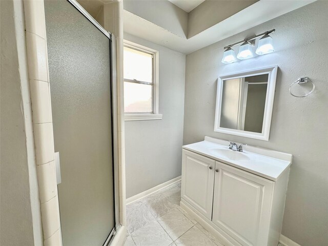 bathroom with vanity, an enclosed shower, and tile patterned floors