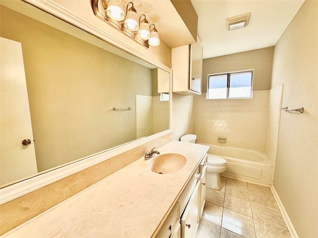 full bathroom featuring tiled shower / bath combo, vanity, tile patterned flooring, and toilet