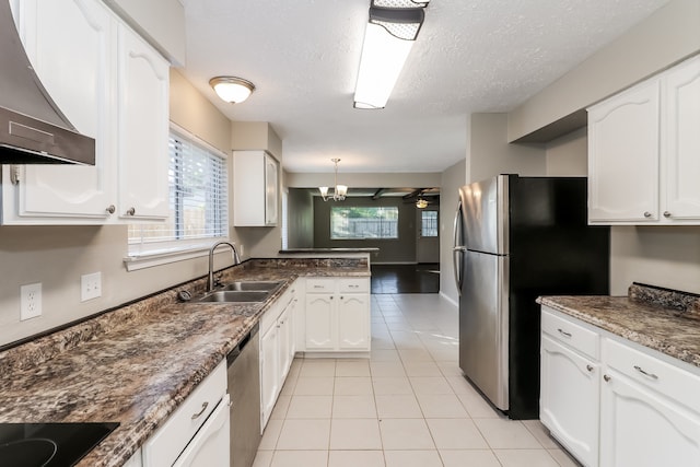 kitchen featuring white cabinetry, sink, exhaust hood, and a wealth of natural light