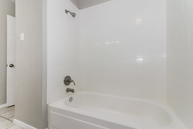 bathroom with tiled shower / bath and tile patterned flooring