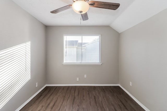 spare room with lofted ceiling, dark hardwood / wood-style floors, and ceiling fan