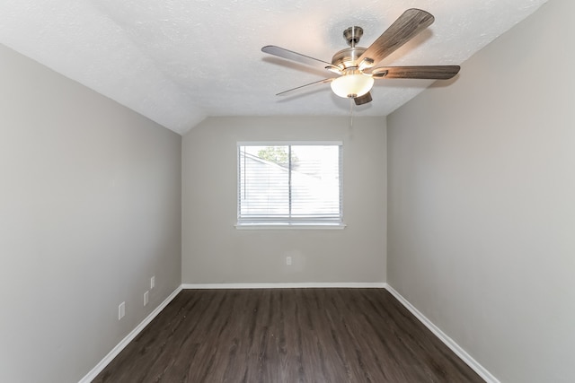 unfurnished room with ceiling fan, a textured ceiling, lofted ceiling, and dark hardwood / wood-style floors