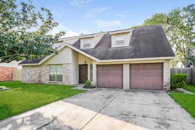 view of front of property with a front yard and a garage