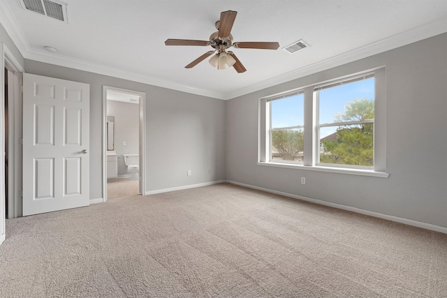 unfurnished bedroom with ornamental molding, connected bathroom, ceiling fan, and light colored carpet