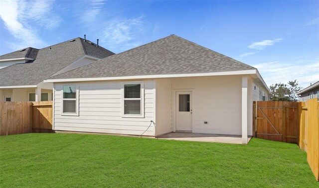 back of property featuring a patio and a lawn