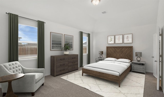 carpeted bedroom with vaulted ceiling and multiple windows