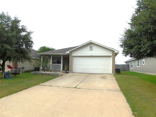 ranch-style home featuring a garage, a porch, and a front lawn