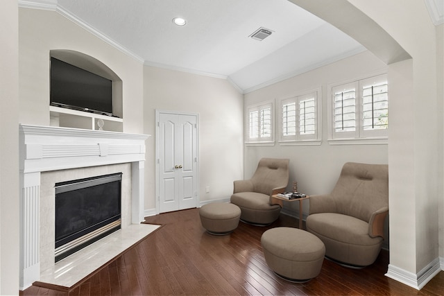 living area with wood-type flooring, lofted ceiling, plenty of natural light, and a fireplace