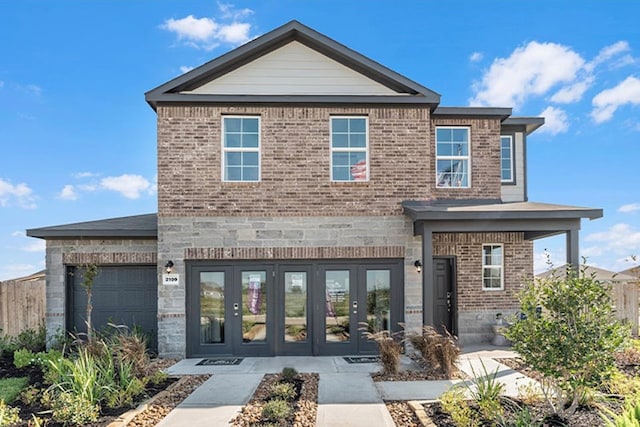 view of front of property with a garage and french doors