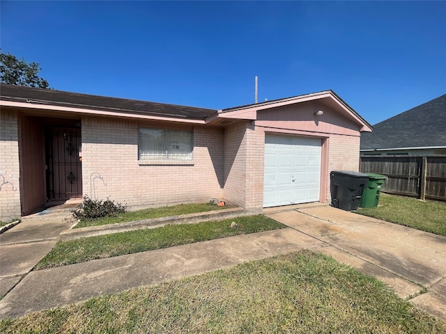 single story home featuring a garage and a front lawn