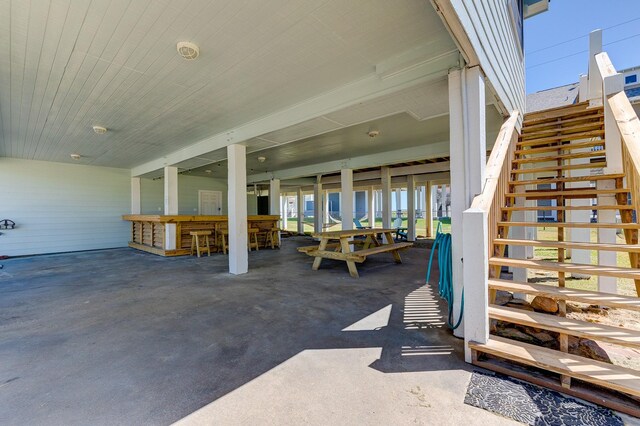 view of patio with stairway and outdoor dry bar