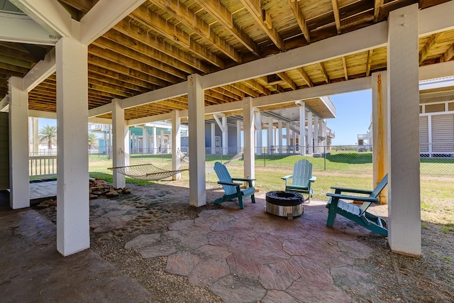 view of patio with an outdoor fire pit and fence