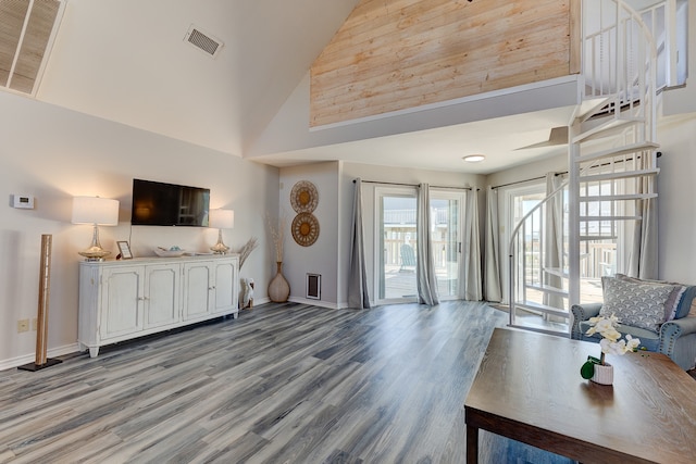 living room with high vaulted ceiling, baseboards, visible vents, and light wood finished floors