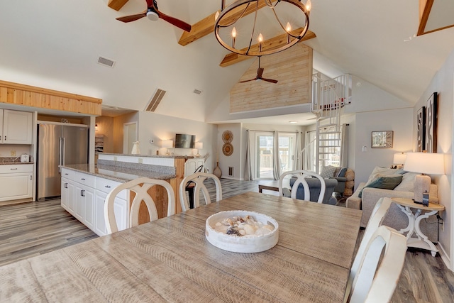 2332 Martinique, Crystal Beach, TX 77650 - dining area featuring ceiling fan, high vaulted ceiling, light wood-style flooring, beamed ceiling, and a chandelier