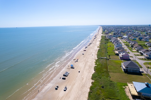 drone / aerial view with a beach view, a residential view, and a water view