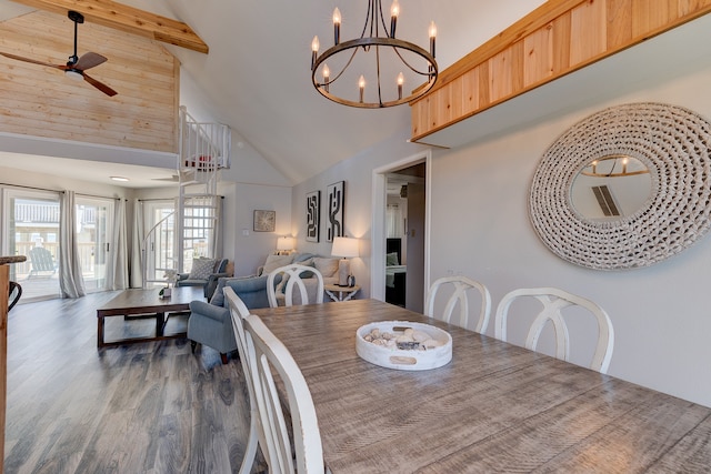 dining space with high vaulted ceiling, dark wood-type flooring, ceiling fan with notable chandelier, and beam ceiling