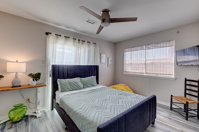 bedroom featuring hardwood / wood-style flooring and ceiling fan