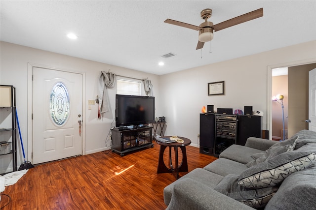 living room featuring ceiling fan and hardwood / wood-style flooring