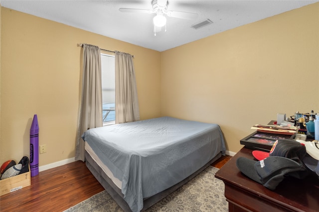 bedroom with ceiling fan and dark hardwood / wood-style floors