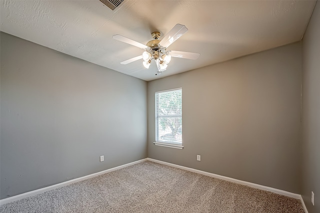 empty room featuring carpet and ceiling fan