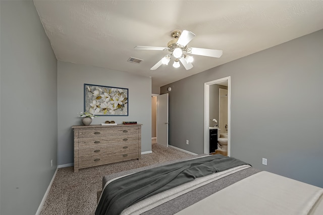 bedroom featuring connected bathroom, ceiling fan, and light colored carpet