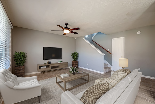 living room featuring wood-type flooring and ceiling fan