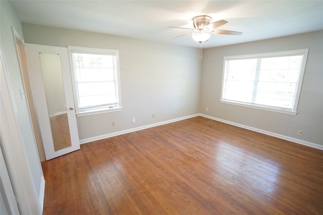 unfurnished room featuring ceiling fan and hardwood / wood-style floors