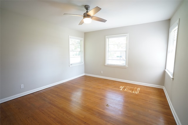 empty room featuring hardwood / wood-style floors and ceiling fan