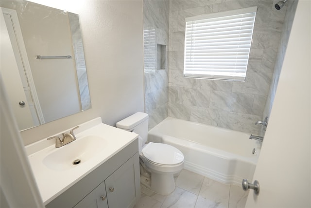 full bathroom with vanity, tiled shower / bath combo, and toilet