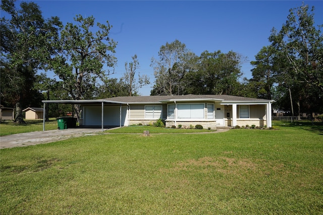 ranch-style home featuring a garage, a front lawn, and a carport