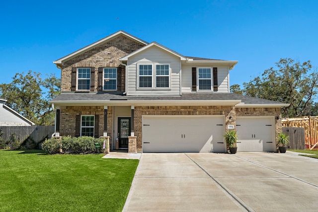 view of front of property featuring a garage and a front lawn