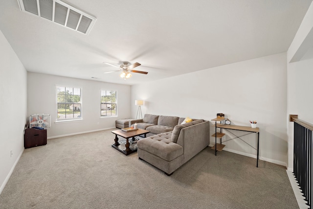 carpeted living room with ceiling fan