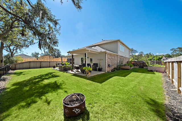 back of property featuring a patio and a yard