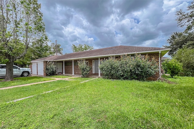 ranch-style house featuring a garage and a front lawn