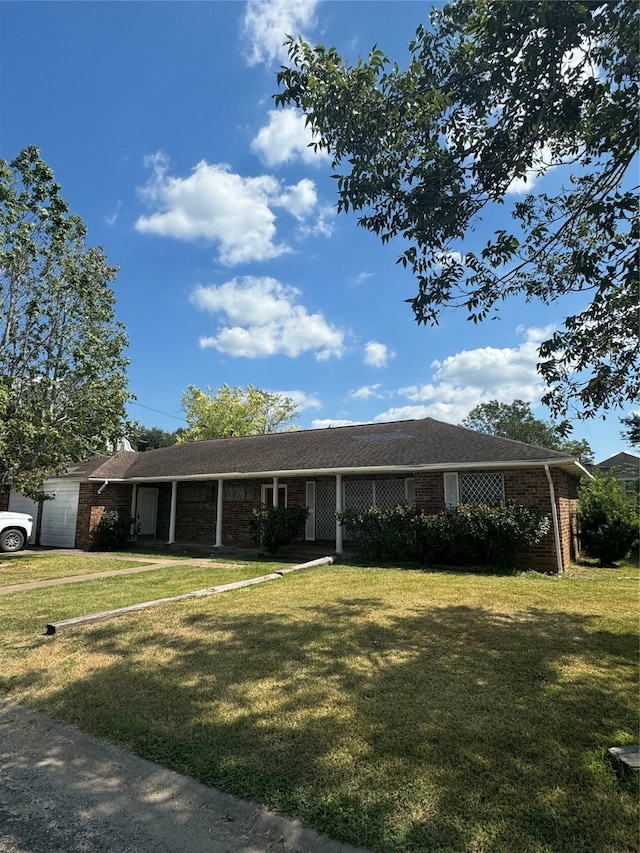 single story home with a front lawn and a garage