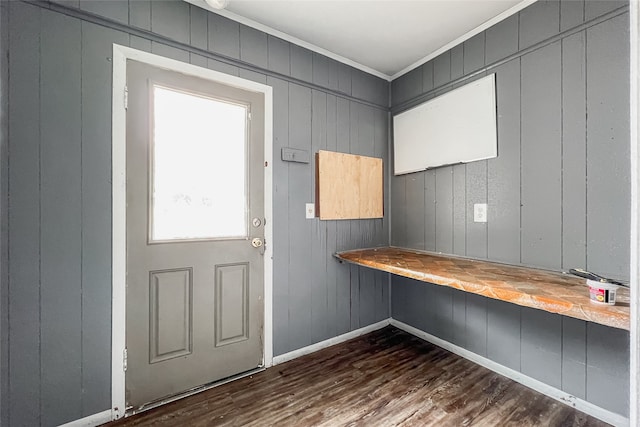 entryway featuring wooden walls, crown molding, and dark hardwood / wood-style flooring