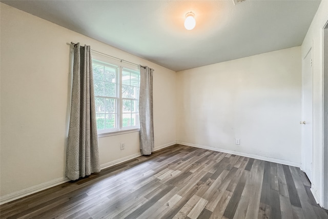 unfurnished room with dark hardwood / wood-style floors