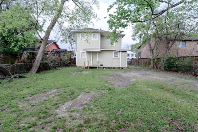 rear view of house with a lawn