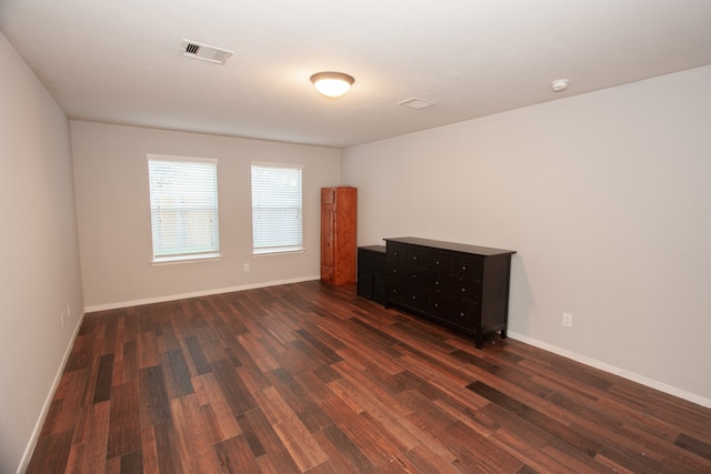 spare room featuring dark hardwood / wood-style floors