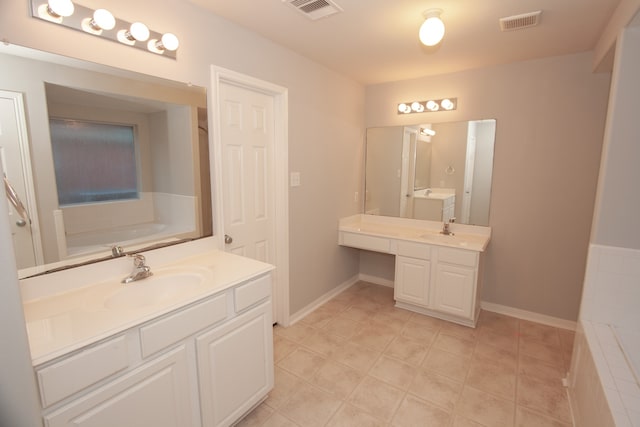 bathroom featuring a bathtub, vanity, and tile patterned floors