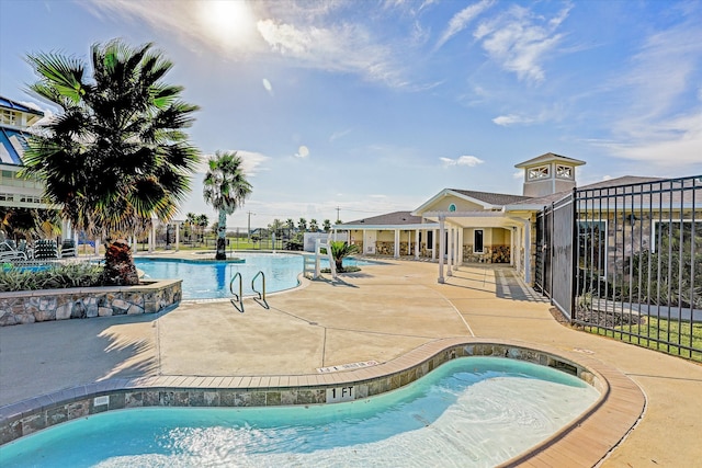 view of swimming pool with a patio area and a jacuzzi