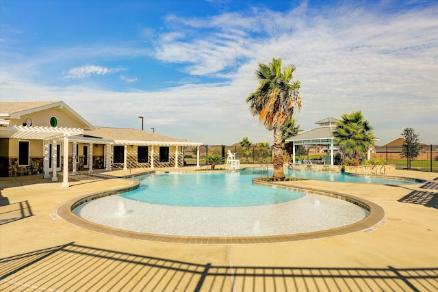 view of swimming pool with a patio area, pool water feature, and a pergola