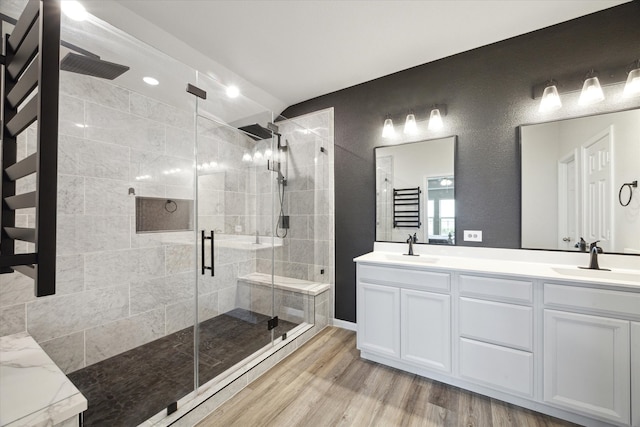 bathroom featuring vanity, hardwood / wood-style flooring, and a shower with door