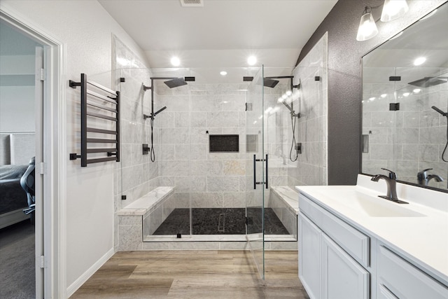 bathroom with vanity, a shower with shower door, and hardwood / wood-style flooring