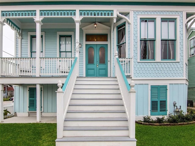 doorway to property featuring a yard and a porch