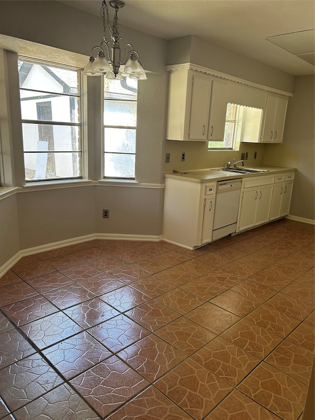 kitchen featuring white cabinets, white dishwasher, hanging light fixtures, sink, and a notable chandelier