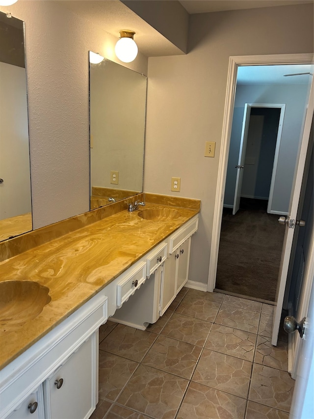 bathroom with tile patterned floors and vanity