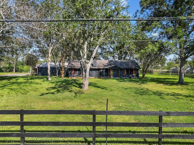 view of front of property with a front yard and a rural view