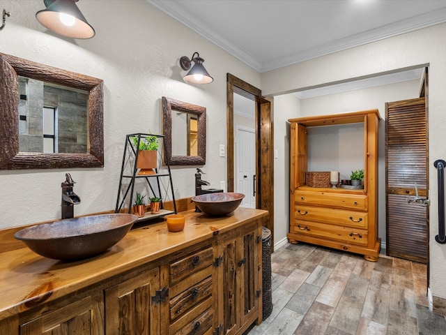 bathroom with vanity, hardwood / wood-style flooring, and ornamental molding